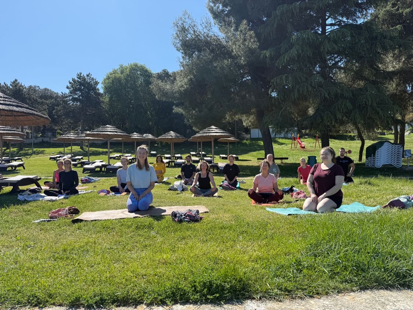 Summer yoga class on the grass by the sea in Vrsar