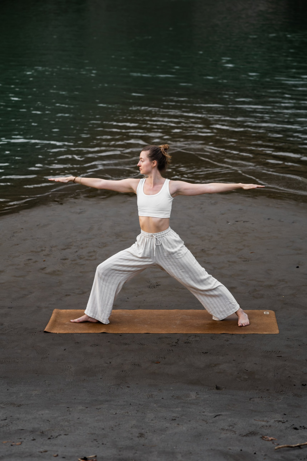 Warrior pose on the beach in Vrsar under the trees